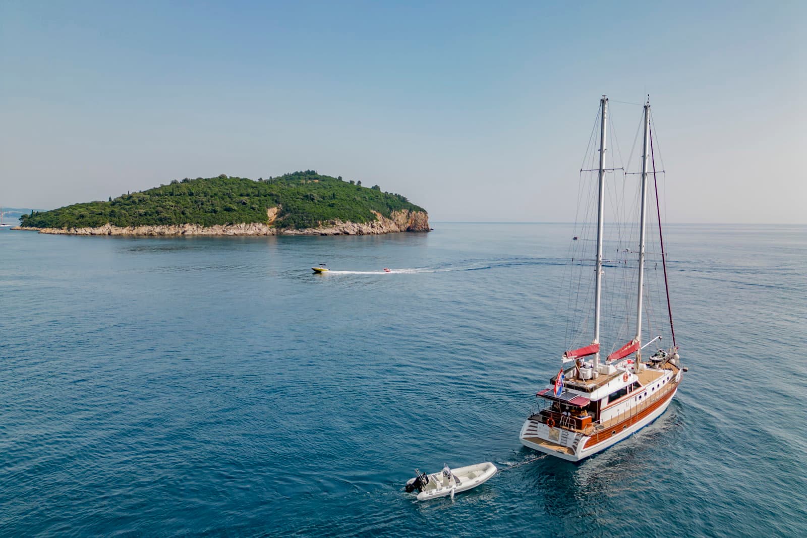 The Croatian coastline at sunset with the gulet at anchor
