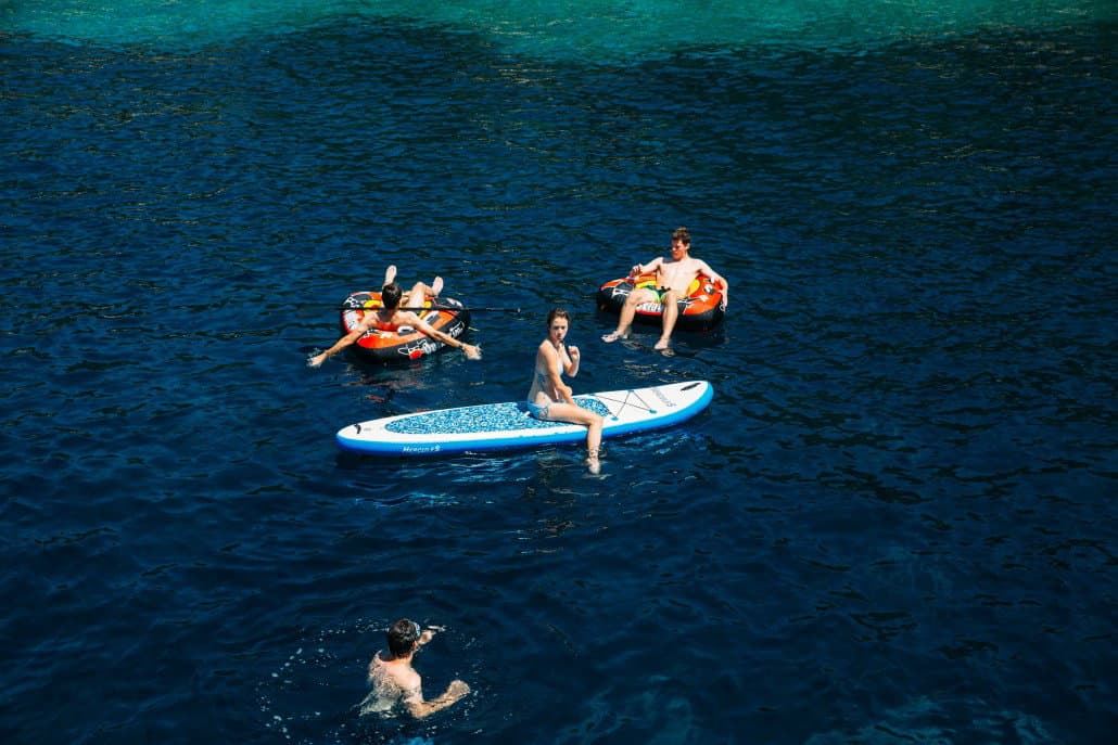 Family enjoying water sports beside the gulet